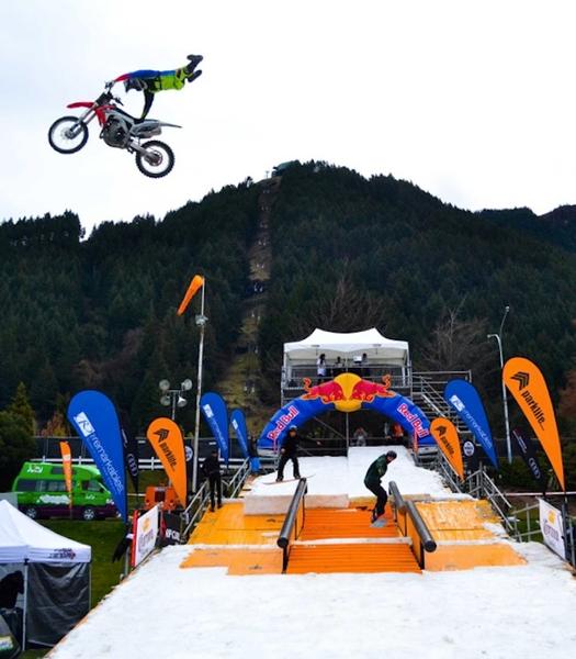 Cameron White (L) and Francis McGuire (R) hit the rails with FMX rider Brenton Drager throwing tricks above them.